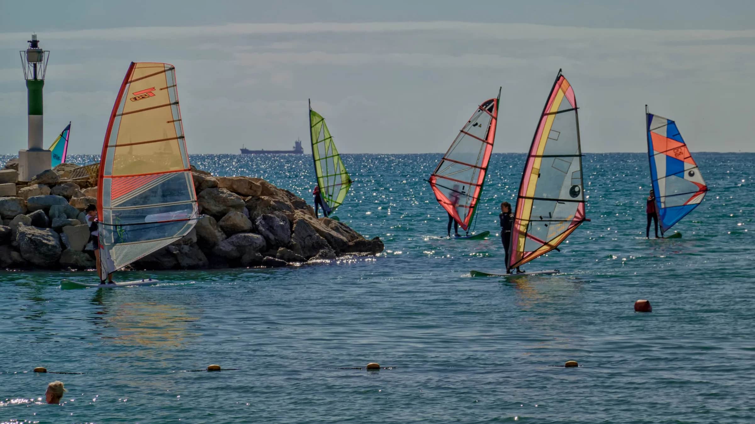 A windsurf group practising together on the water