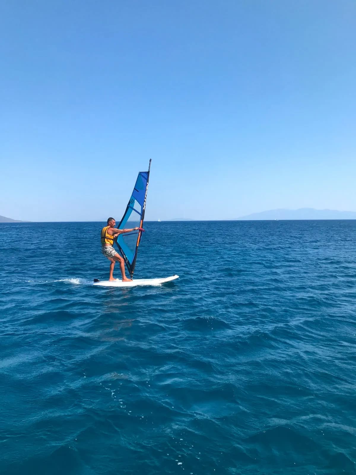 A participant practising basic windsurf control on open water